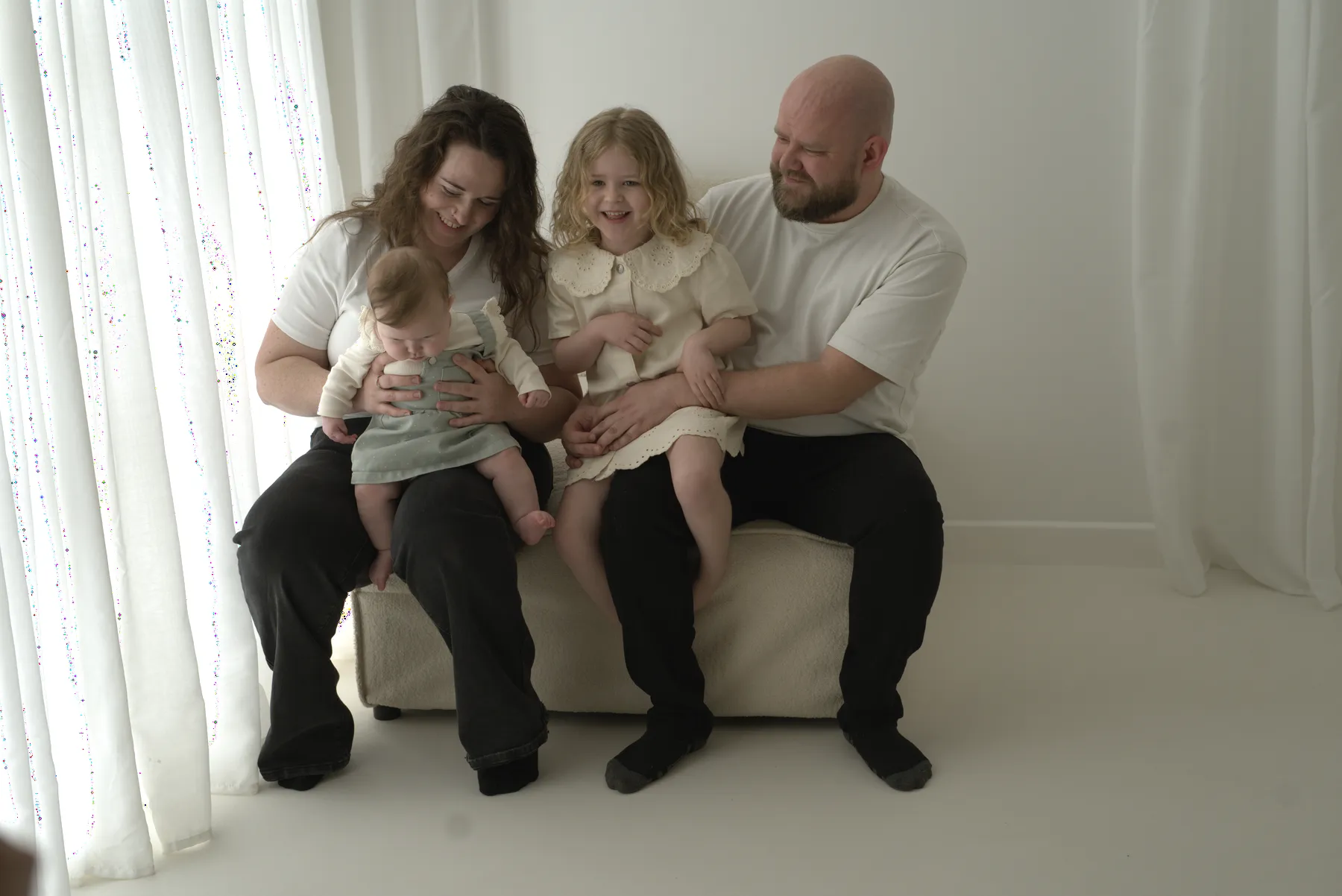 Parents with two young daughters in the studio