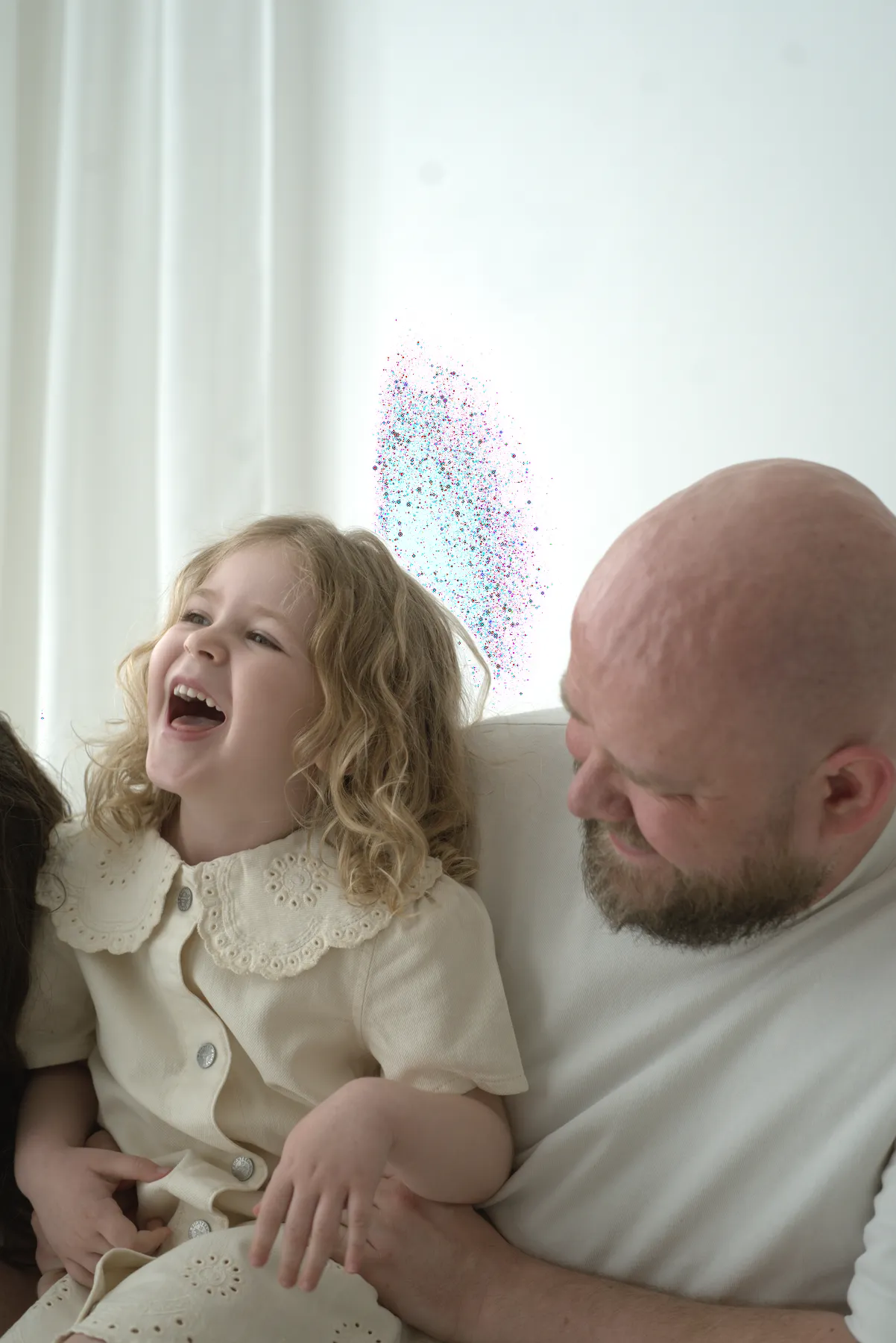 Father and young daughter laughing together