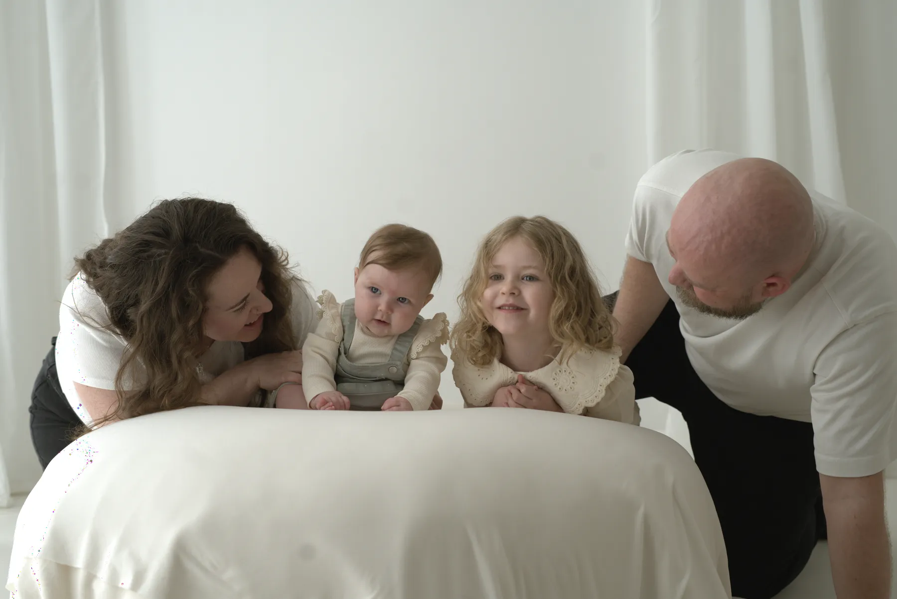 Family gathered closely around a wrapped newborn