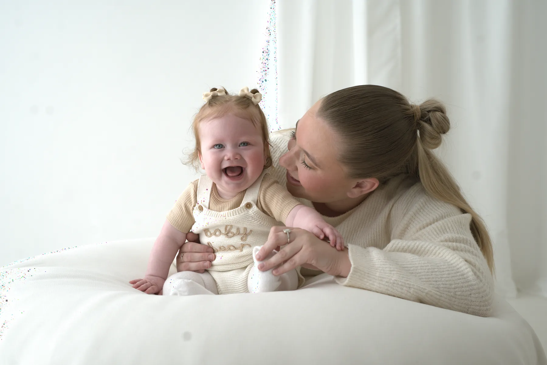 Mother cuddling her laughing young child